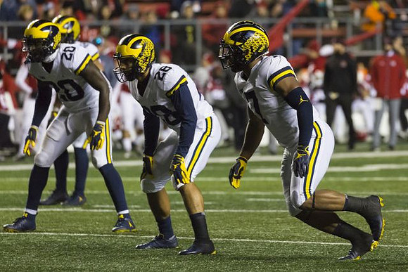 Brad Hawkins (20), Brandon Watson (28), and Khaleke Hudson (7)