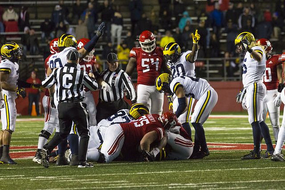 Khaleke Hudson (7), Bryan Mone (90), Aidan Hutchinson (97), Brad Hawkins (20), Tyree Kinnel (23), and Chase Winovich (15)