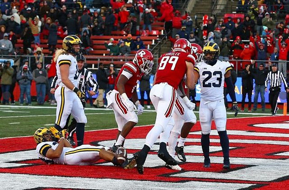 Brandon Watson (28), Chase Winovich (15), and Tyree Kinnel (23)