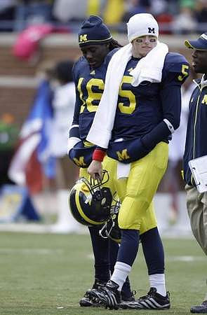 Denard Robinson (16) and Tate Forcier (5)
