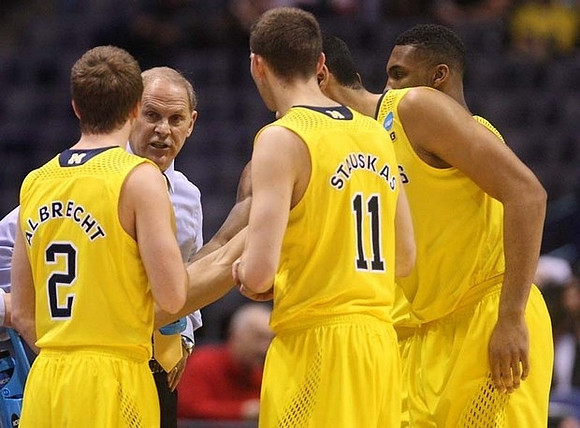 Spike Albrecht (2), John Beilein, Nik Stauskas (11), Jordan Morgan (52), and Zak Irvin (21)