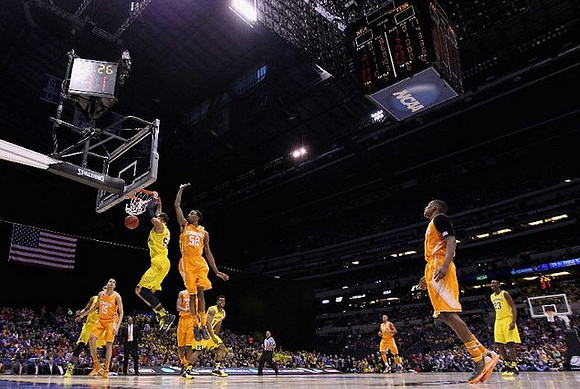 Jordan Morgan (52), Derrick Walton Jr. (10), and Caris LeVert (23)