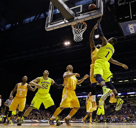 Jordan Morgan (52), Glenn Robinson III (1), and Caris LeVert (23)