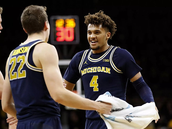 Duncan Robinson (22) and Isaiah Livers (4)