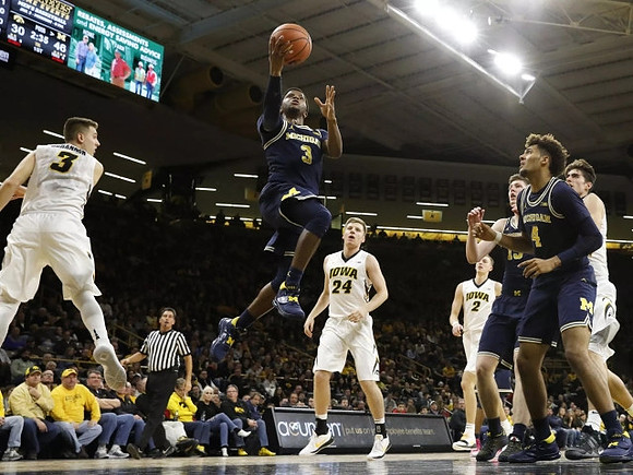 Zavier Simpson (3), Moritz Wagner (13), and Isaiah Livers (4)