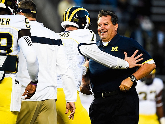 Shane Morris (7) and Brady Hoke