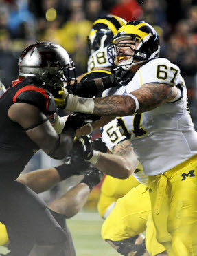 Jake Butt (88), Mason Cole (52), and Kyle Kalis (67)