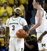 Zavier Simpson (3) and Jon Teske (15)