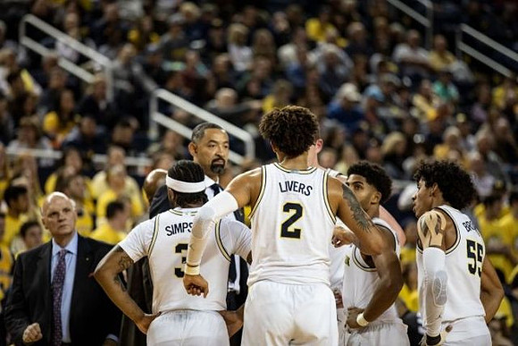Phil Martelli, Zavier Simpson (3), Juwan Howard, Isaiah Livers (2), David DeJulius (0), and Eli Brooks (55)
