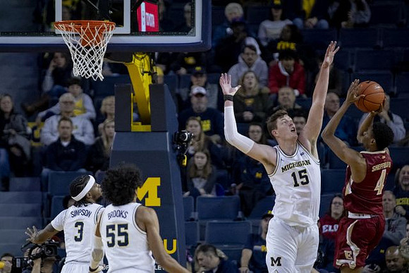 Zavier Simpson (3), Eli Brooks (55), and Jon Teske (15)