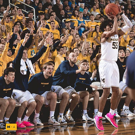 Eli Brooks (55) and Michigan Team