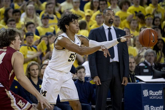 Eli Brooks (55) and Juwan Howard