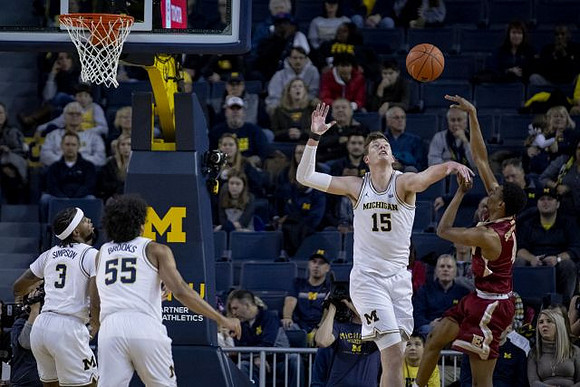 Zavier Simpson (3), Eli Brooks (55), and Jon Teske (15)