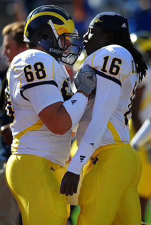 Mike Martin (68) and Denard Robinson (16)