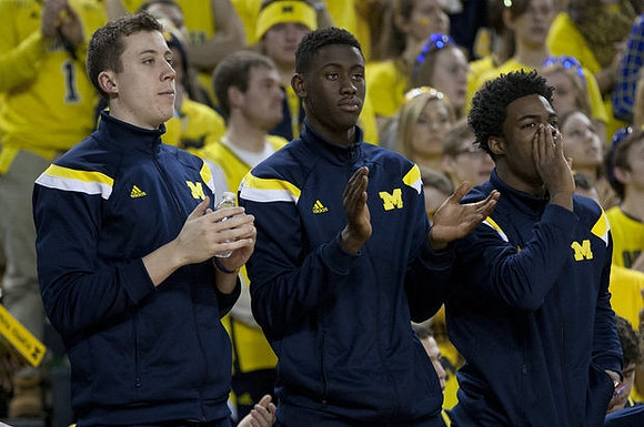 Duncan Robinson (22), Caris LeVert (23), and Derrick Walton Jr. (10)