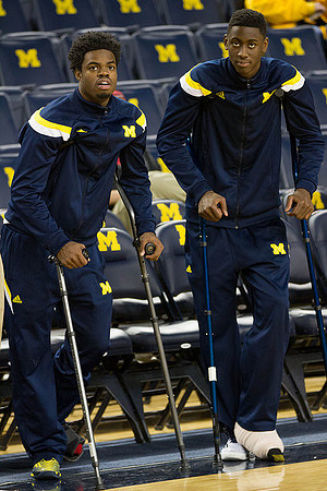 Derrick Walton Jr. (10) and Caris LeVert (23)
