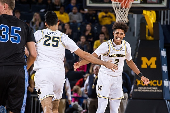 Naji Ozeir (25) and Jordan Poole (2)