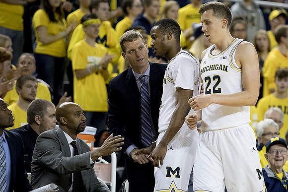 Saddi Washington, Luke Yaklich, Muhammad-Ali Abdur-Rahkman (12), and Duncan Robinson (22)