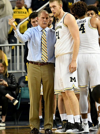 John Beilein, Austin Davis (51), and Isaiah Livers (4)