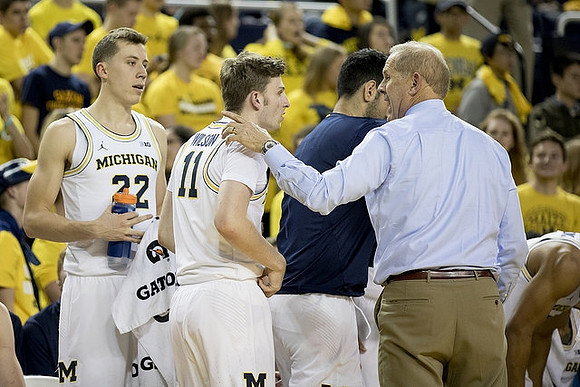 Duncan Robinson (22), Luke Wilson (11), and John Beilein