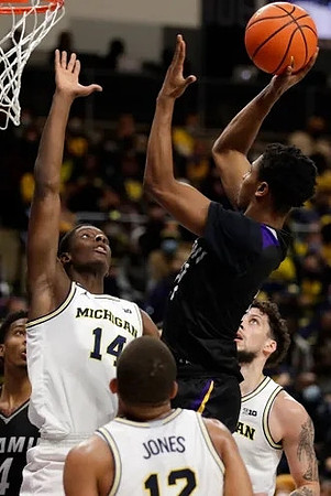 Moussa Diabate (14), DeVante' Jones (12), and Brandon Johns Jr. (23)