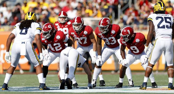Devin Gil (8) and Hassan Haskins (25)