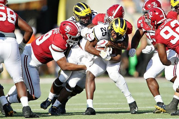 Ben Bredeson (74) and Hassan Haskins (25)