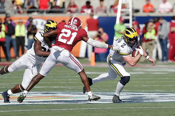 Hassan Haskins (25) and Shea Patterson (2)