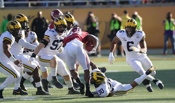 Aidan Hutchinson (97), Daxton Hill (30), and Josh Uche (6)
