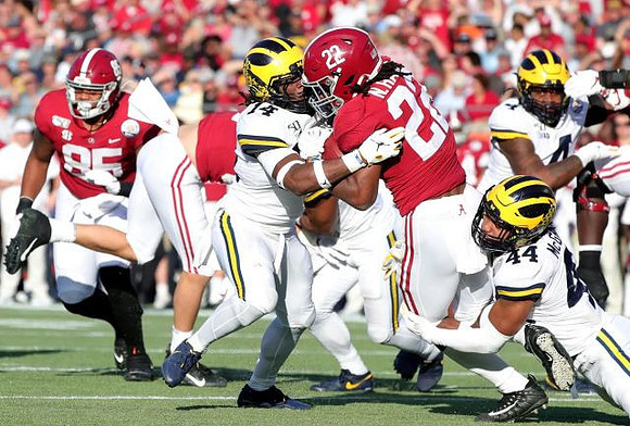 Josh Metellus (14), Cameron McGrone (44), and Michael Danna (4)