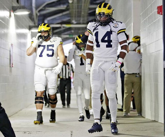 Jon Runyan Jr. (75) and Josh Metellus (14)