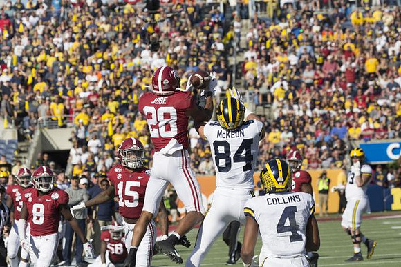 Sean McKeon (84), Nico Collins (4), and Jalen Mayfield (73)
