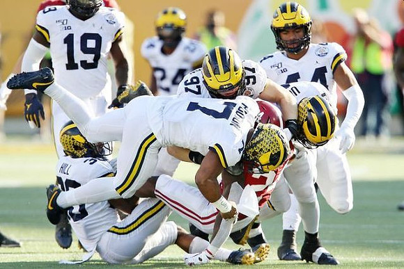 Kwity Paye (19), Daxton Hill (30), Khaleke Hudson (7), Aidan Hutchinson (97), Lavert Hill (24), and Cameron McGrone (44)