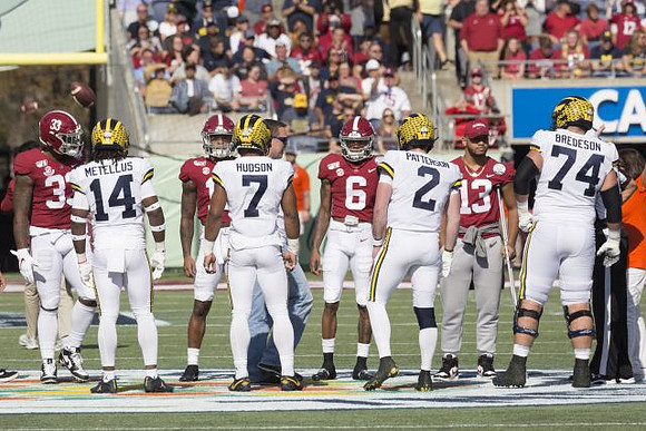 Josh Metellus (14), Khaleke Hudson (7), Shea Patterson (2), and Ben Bredeson (74)