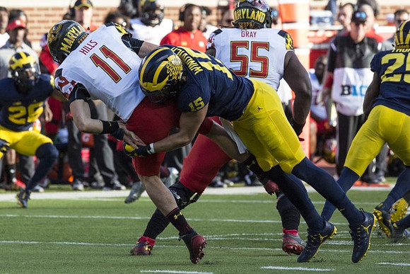 Jourdan Lewis (26), Chase Winovich (15), and Dymonte Thomas (25)