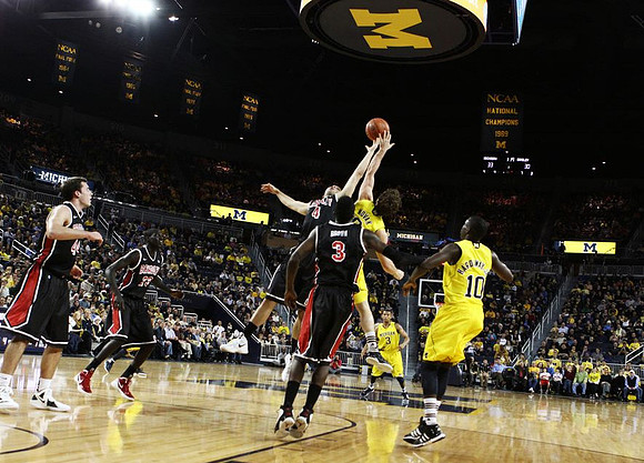 Zack Novak (0), Tim Hardaway Jr. (10), and Trey Burke (3)