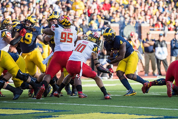 Henry Poggi (19), Mason Cole (52), and De'Veon Smith (4)