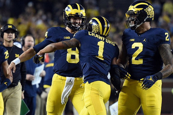 Jim Harbaugh, John O'Korn (8), Kekoa Crawford (1), and Devin Asiasi (2)