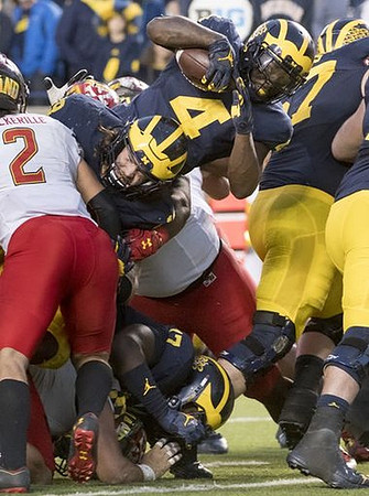 Henry Poggi (19), Tyrone Wheatley Jr. (17), De'Veon Smith (4), and Kyle Kalis (67)
