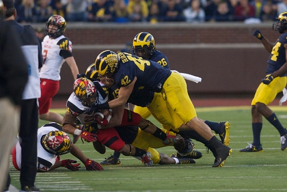 Chase Winovich (15), Ben Gedeon (42), and Jourdan Lewis (26)