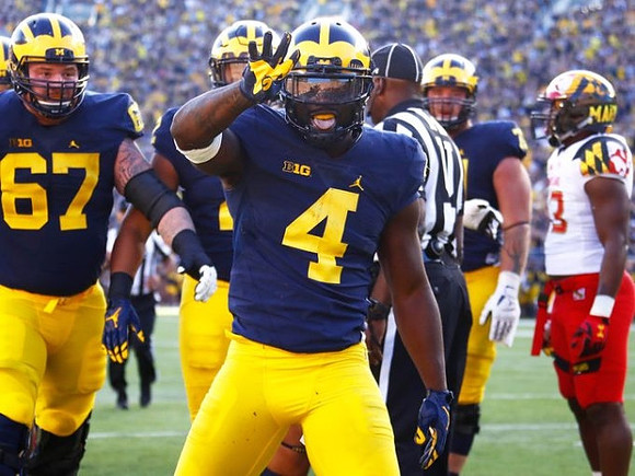 Kyle Kalis (67) and De'Veon Smith (4)