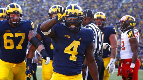 Kyle Kalis (67) and De'Veon Smith (4)