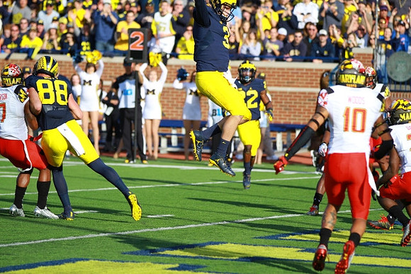 Jake Butt (88), Wilton Speight (3), and Karan Higdon (22)