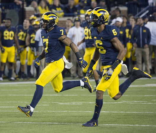 Khaleke Hudson (7), Keith Washington (6), and Kenny Allen (91)