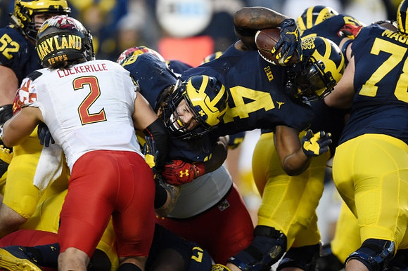 Mason Cole (52), Henry Poggi (19), De'Veon Smith (4), and Erik Magnuson (78)