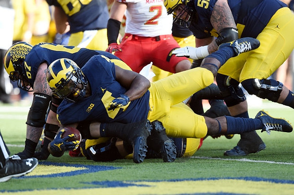 Kyle Kalis (67) and De'Veon Smith (4)