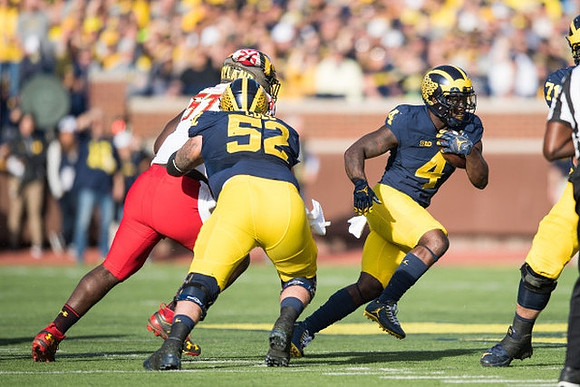 Mason Cole (52) and De'Veon Smith (4)