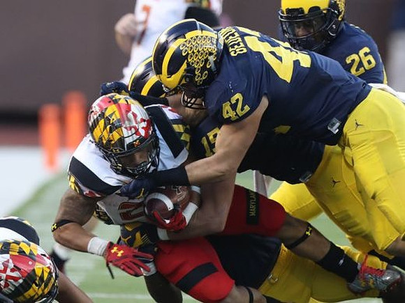 Chase Winovich (15), Ben Gedeon (42), and Jourdan Lewis (26)
