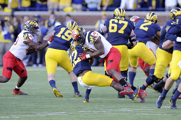 Henry Poggi (19), Karan Higdon (22), Kyle Kalis (67), and Devin Asiasi (2)