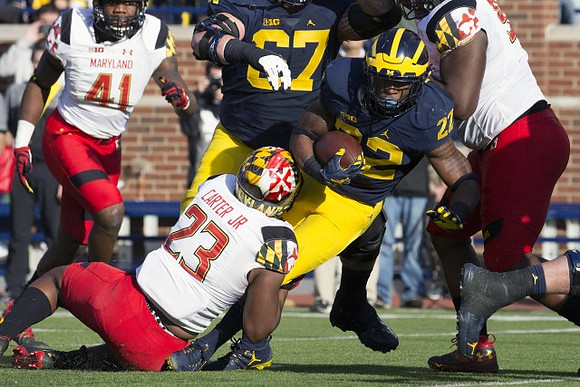 Kyle Kalis (67) and Karan Higdon (22)